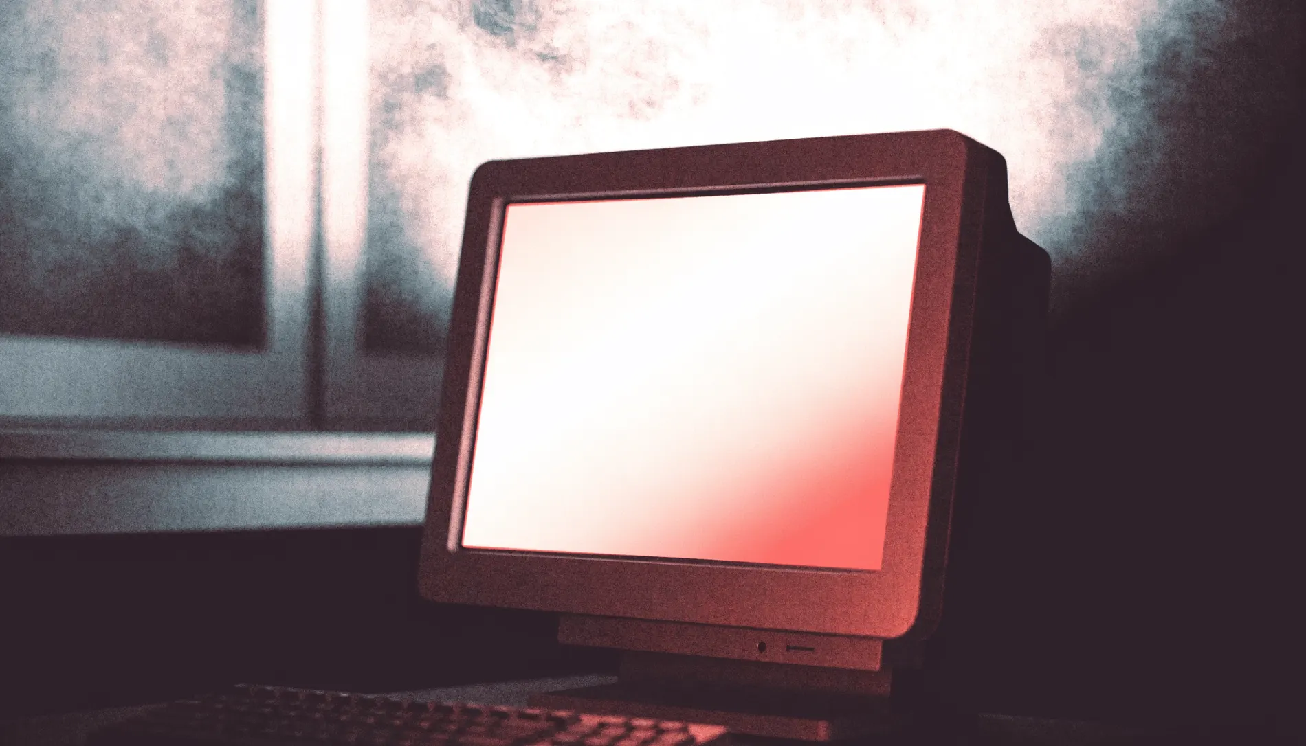 A monitor glowing softly in a dim room