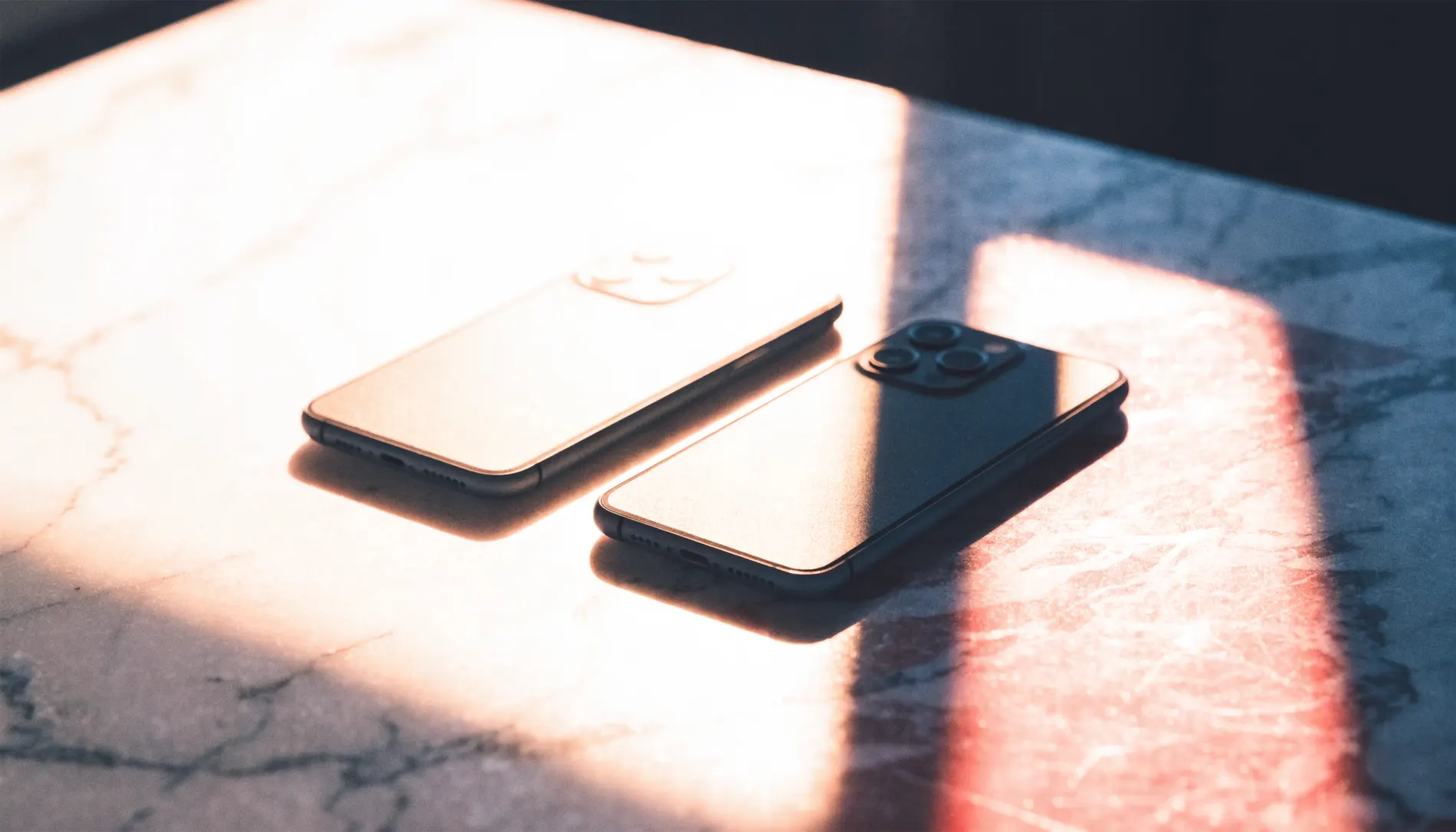 Two phones side by side on a marble counter